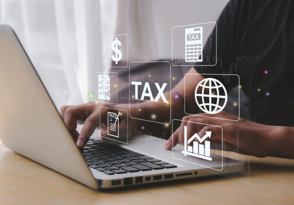 Completing personal income tax forms online and paying taxes using a computer.  data analysis  government, state tax, documents, tax return calculations, reports, financial research